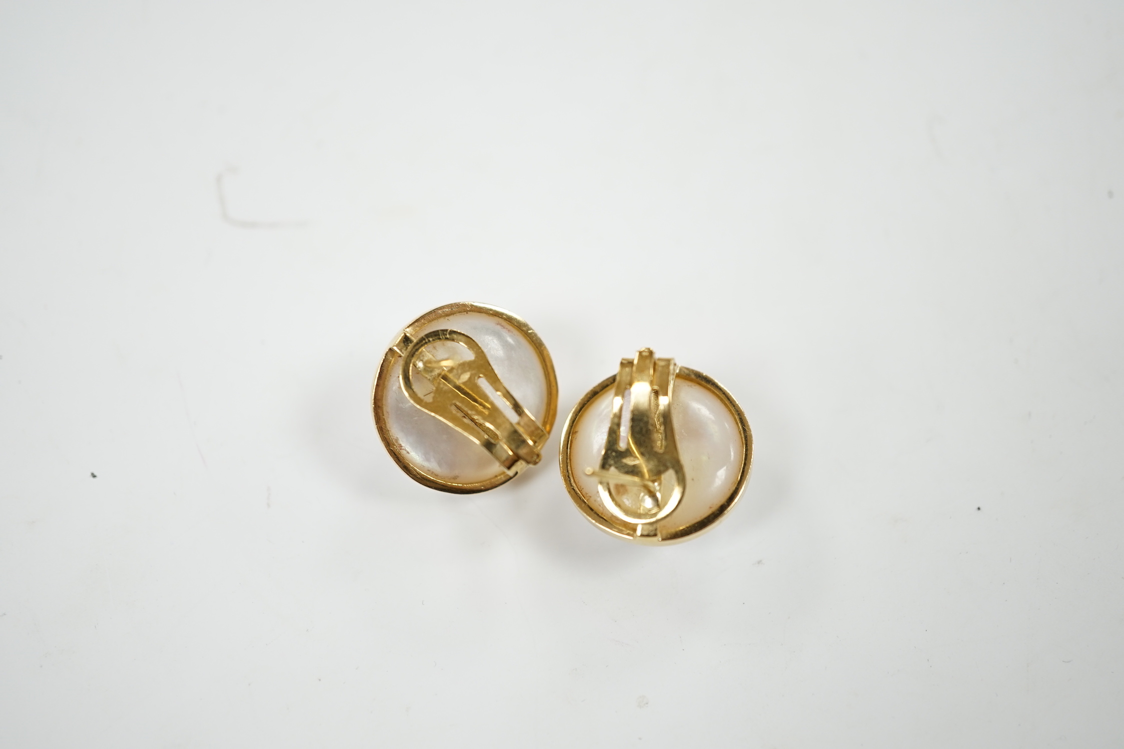 A modern pair of 750 yellow metal and mabe pearl set earrings, diameter 18mm, gross weight 11.9 grams.